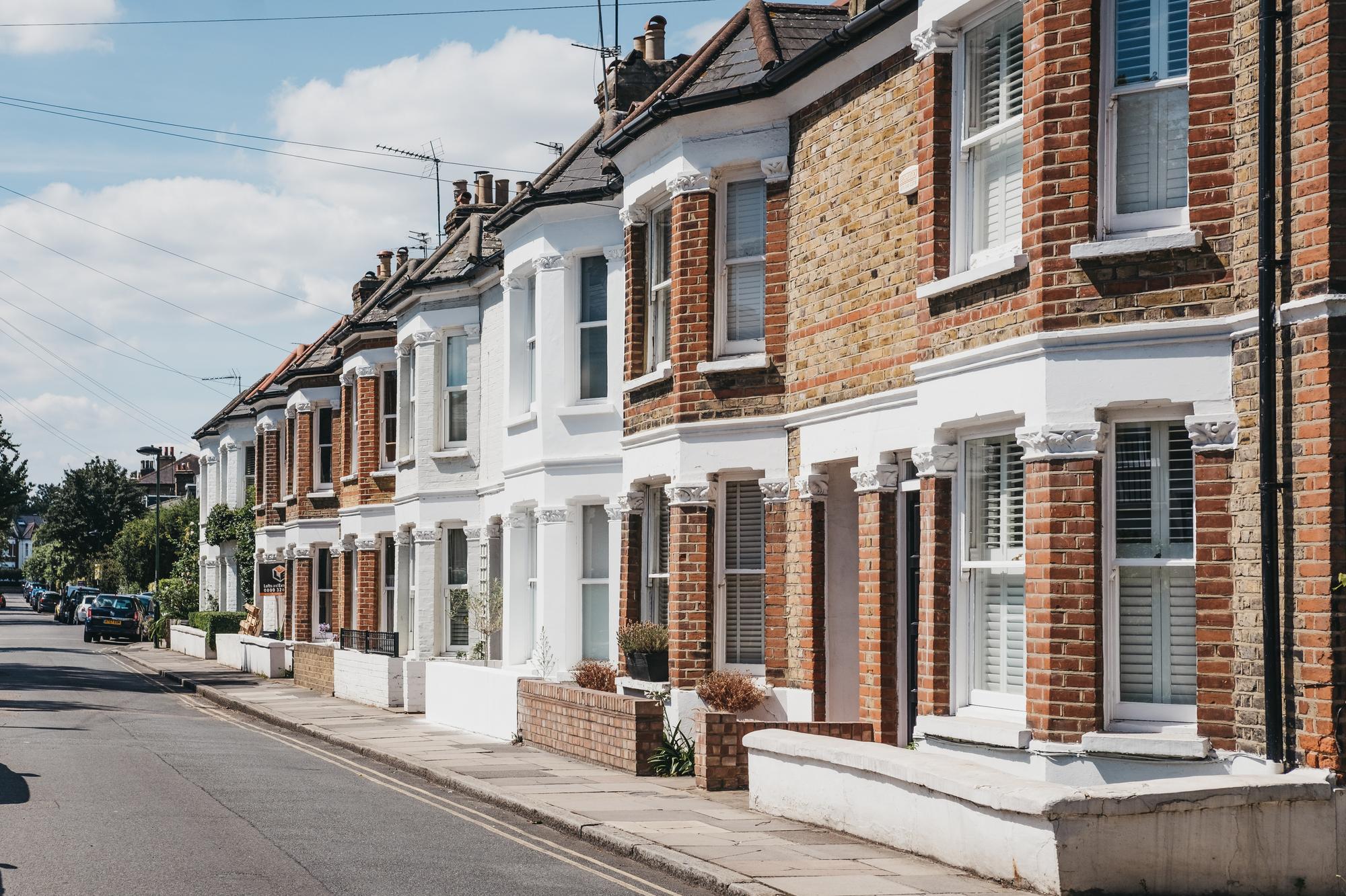 A terrace of brick-built homes on a sunny street
